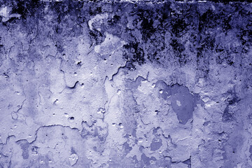Grungy dirty plaster wall with peeling paint. Deep blue color style.