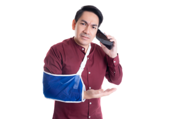Man with his arm in a sling makes a phone call, expressing concern and frustration Handsome guy dealing with an injury, potentially seeking assistance or discussing urgent matter with disappointment
