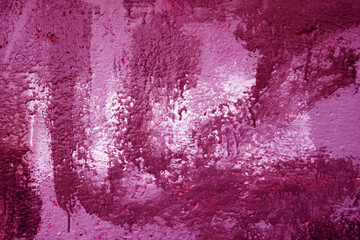 Pink paint brush strokes on cement building wall.