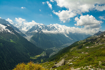 Fototapeta premium Picturesque panoramic view of the snowy Alps mountains and meadows while hiking Tour du Mont Blanc. Popular hiking route. Alps, Chamonix-Mont-Blanc region, France, Europe.