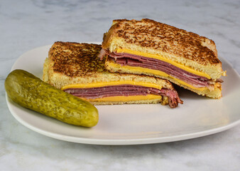 toasted pastrami melt sandwich with pickle