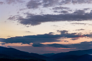 Beautiful landscape with clouds in the mountains at sunrise.
