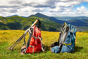 Hiking in the mountains with two backpacks in the summer.