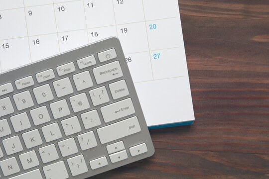 work life balance concept , computer keyboard with calendar on wood table