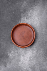 Empty ceramic plate on a dark textured background