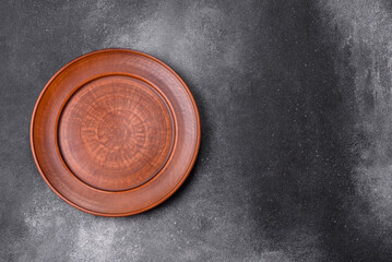 Empty ceramic plate on a dark textured background