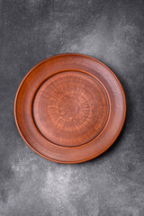Empty ceramic plate on a dark textured background