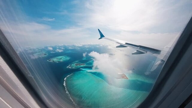 Airplane flies over the islands in the Maldives