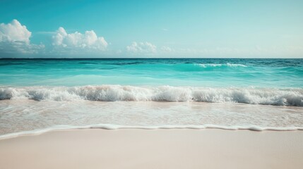 Turquoise sea meeting a white sandy beach, with gentle waves and clear skies, perfect for a tranquil Caribbean vacation.