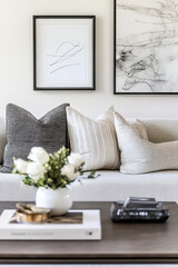 A picture frame displaying elegant line art sits on a coffee table in a stylish living room