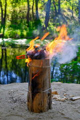 cooking fried meat in a frying pan on a Finnish or Swedish candle
