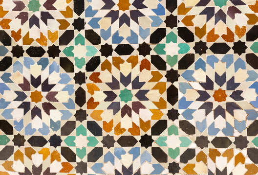 Closeup of colorful mosaic geometric pattern zellige tiles at Ben Youssef Madrasa in Marrakech, Morocco - intricate Morrocan design, ornate traditional art, decor and architectural heritage