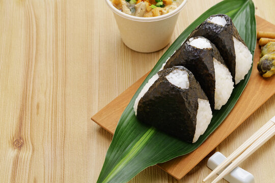homemade onigiri (rice balls), traditional Japanese food.　The filling is salmon flakes, umeboshi(pickled plums), and mentaiko(spicy cod roe).