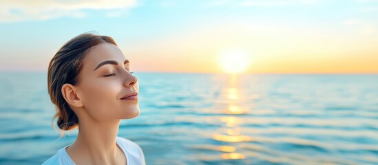 A young woman enjoys a peaceful moment by the ocean at sunset, embracing nature and tranquility under the colorful sky.