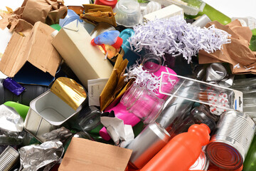 garvage, close up of a group of plastic containers of glass, cans and paper on a white background