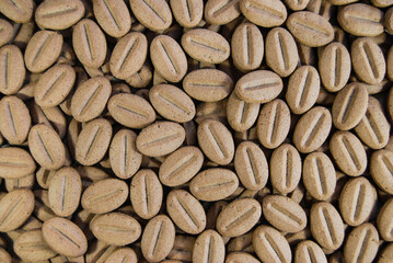 cookies in the shape of coffee beans are laid out on the surface