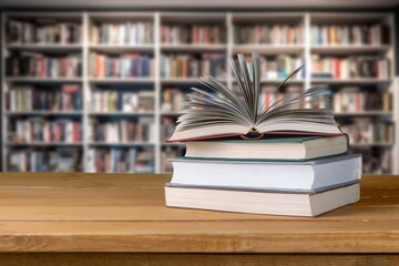 pile of reading books on table in library, education
