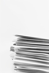 Close-up of a stack of papers against a white background, emphasizing their crispness organization