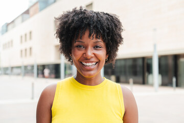 Close up individual portrait of one teenage african american girl smiling and looking at camera...