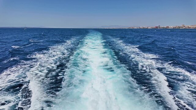 A sea trail from a ship with frothy blue waves. Breathtaking seascape in slow motion