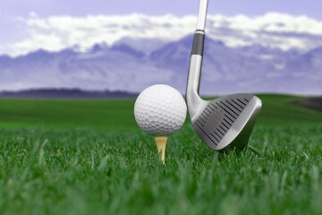 White golf balls, steel clubs on green grass