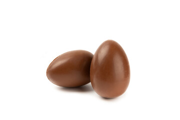Easter chocolate egg isolated on white background. Easter celebration concept. Happy Easter. Chocolate sweet eggs. Candies on textured wooden table. Space for text.Copy space