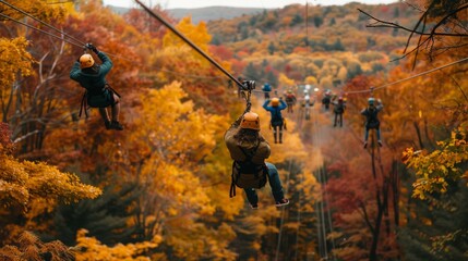 Adventurers glide through vibrant autumn trees on a zipline, surrounded by stunning fall colors in a mountainous landscape.