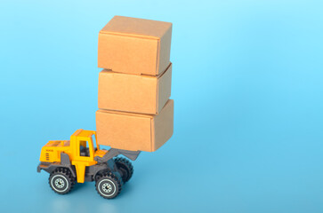 The image depicts a yellow toy forklift lifting a stack of three cardboard boxes, symbolizing the transportation and logistics industry.