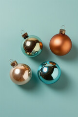 Christmas tree ornaments on light blue background, top view. Colorful festive decoration balls