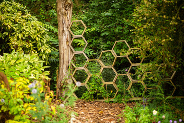 Wooden Hexagonal Garden Trellis in Lush Greenery with Vibrant Foliage and Flowers