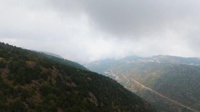 Stunning 4K drone footage of the Sarawat Mountains in Baha, Saudi Arabia. Capture the dramatic contrast of verdant peaks against a backdrop of swirling clouds. Ideal for travel, nature, and cinematic 