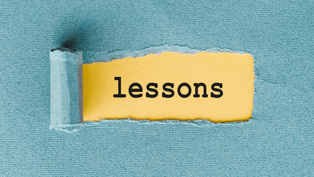 A yellow piece of paper has been torn to reveal the word lessons written in black on a blue background.