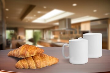 Fresh tasty croissants and coffee in modern kitchen