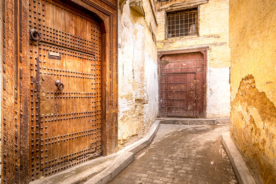 Fez, Morocco - March 19, 2024: View on the narrow streets with nice doors of the old souk of the medina in Fez, Morocco.