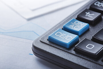 calculator and financial charts. Investment and capital accumulation concept