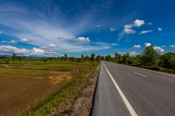 Fototapeta premium Nature Wallpaper (Mountains, Green Fields, Roadside Accommodation, Twilight Sky) The beauty of nature while traveling, with the wind blowing through the blurred leaves.