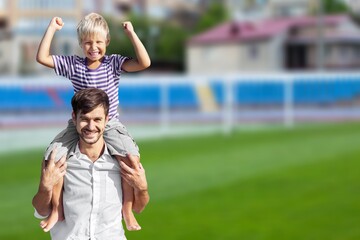 Obraz premium Happy father with small son on field at summer