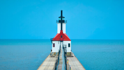 Aerial View of Red-Roofed Lighthouse on Pier Extending into Lake Michigan