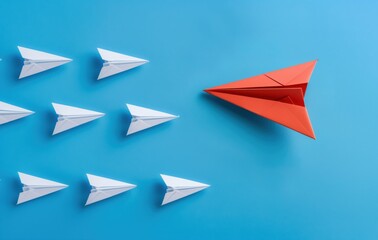 A red paper airplane is flying in front of a row of white paper airplanes