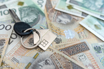 stack of Polish money PLN banknotes with house key to the flat lying