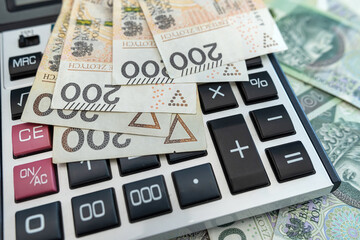 polish zloty money banknotes with calculator. 200 100 pln bills business concept