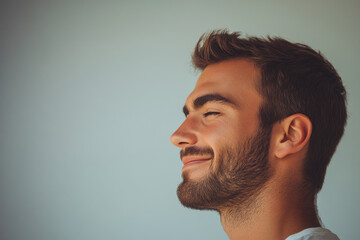 Obraz premium A close up of a man's face with his eyes closed