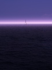 Fototapeta premium Strong light beyond the horizon on the sea in the morning and a small sailboat, minimalism in Greece