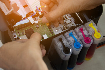 Top view of technician repairing printer