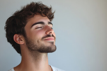 Fototapeta premium A close up of a man's face with his eyes closed