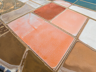 Aerial view of La Manga salt mines, salt table, with vivid orange, red, pink colors palette ready for a painter to paint