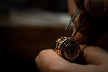 craftsman making diamond ring. hand made jewelery. Put diamond gem ring. diamond ring production...