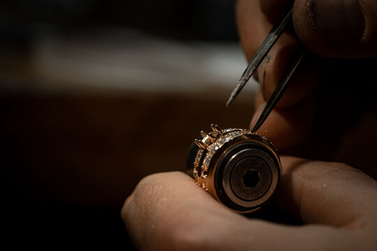 craftsman making diamond ring. hand made jewelery. Put diamond gem ring. diamond ring production craftman workshop. solitaire ring making
