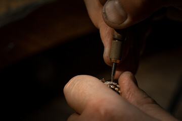craftsman making diamond ring. hand made jewelery. Put diamond gem ring. diamond ring production craftman workshop. solitaire ring making
