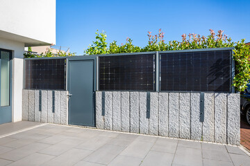 Balcony solar power plant mounted on garden  fence.  Modern Balcony Apartment Solar power panel. © Brebca